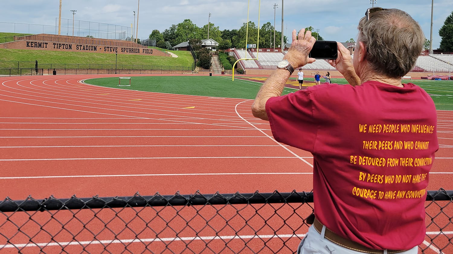 Steve Spurrier takes a picture of a sign that reads "Kermit Tipton Stadium - Steve Spurrier Field" while returning to Science Hill High School for a 60-year class reunion in 2022.