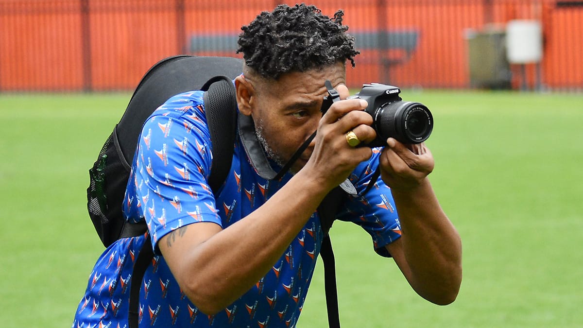 Corey Williams uses his camera to shoot at Ben Hill Griffin Stadium in November 2025.