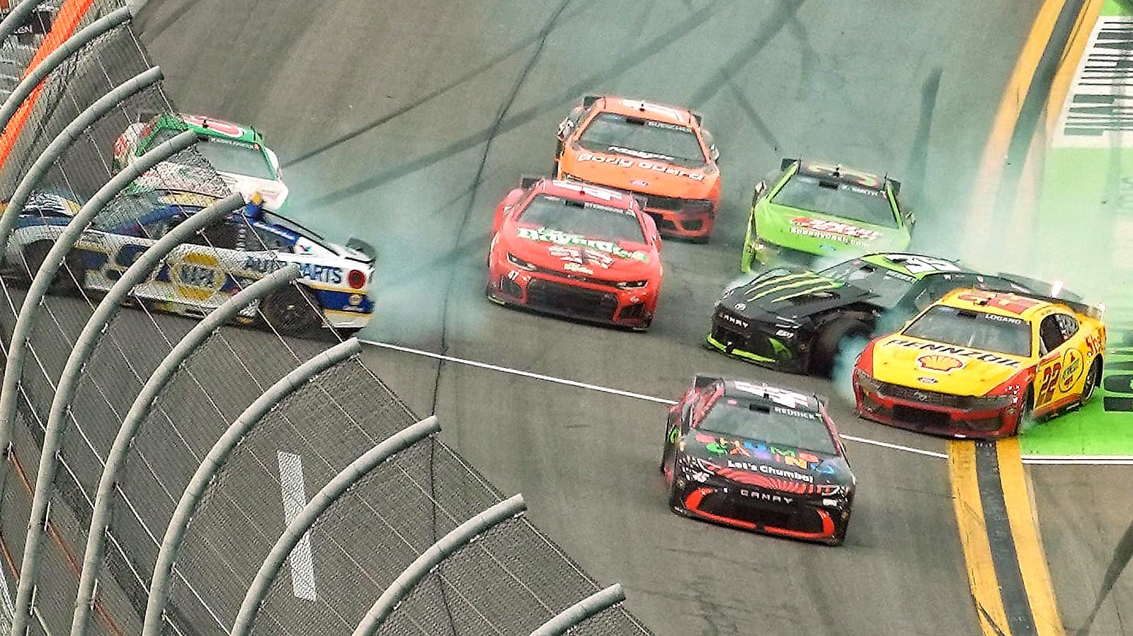 Tyler Reddick (45) sneaks through the final crash involving Joey Logano (22), Chase Elliott (9) and others during the last lap of the Daytona 500, Sunday, Feb. 15, 2026 at Daytona International Speedway.