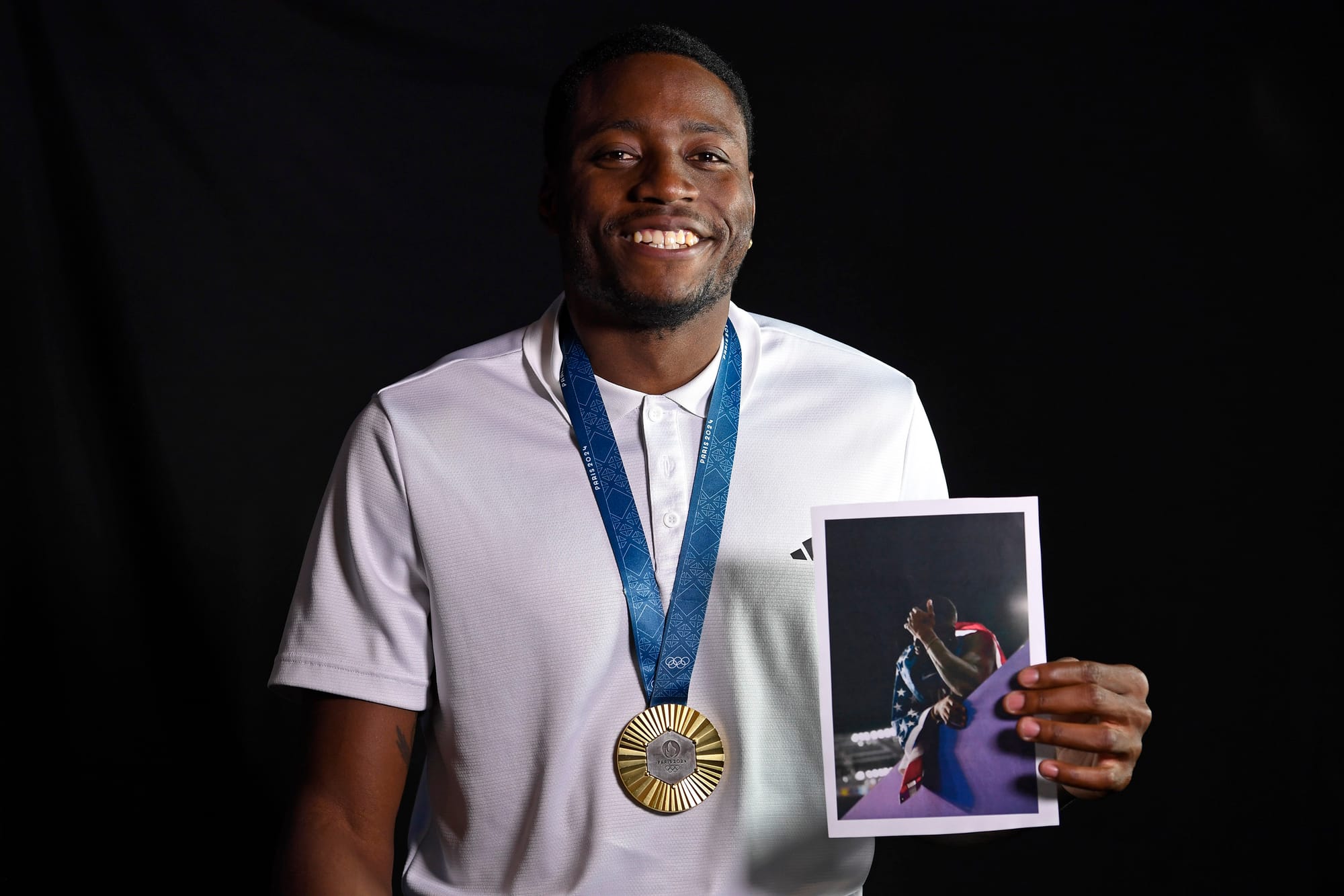 Grant Holloway poses with Anderson Bobo's photo during a photoshoot in Weimer Hall at the University of Florida on Feb. 17, 2026.