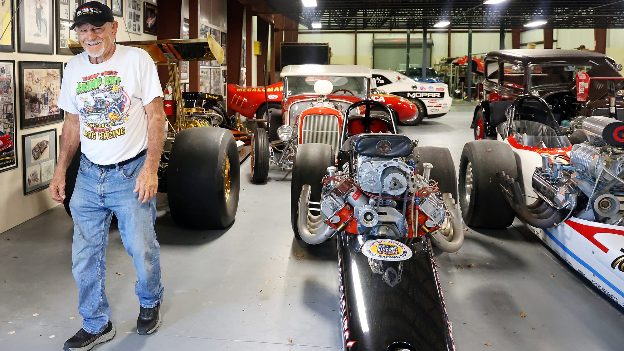 Don "Big Daddy" Garlits stands, smiling, next to the car collection that makes up part of his musuem on Monday, Sept. 15, 2025.