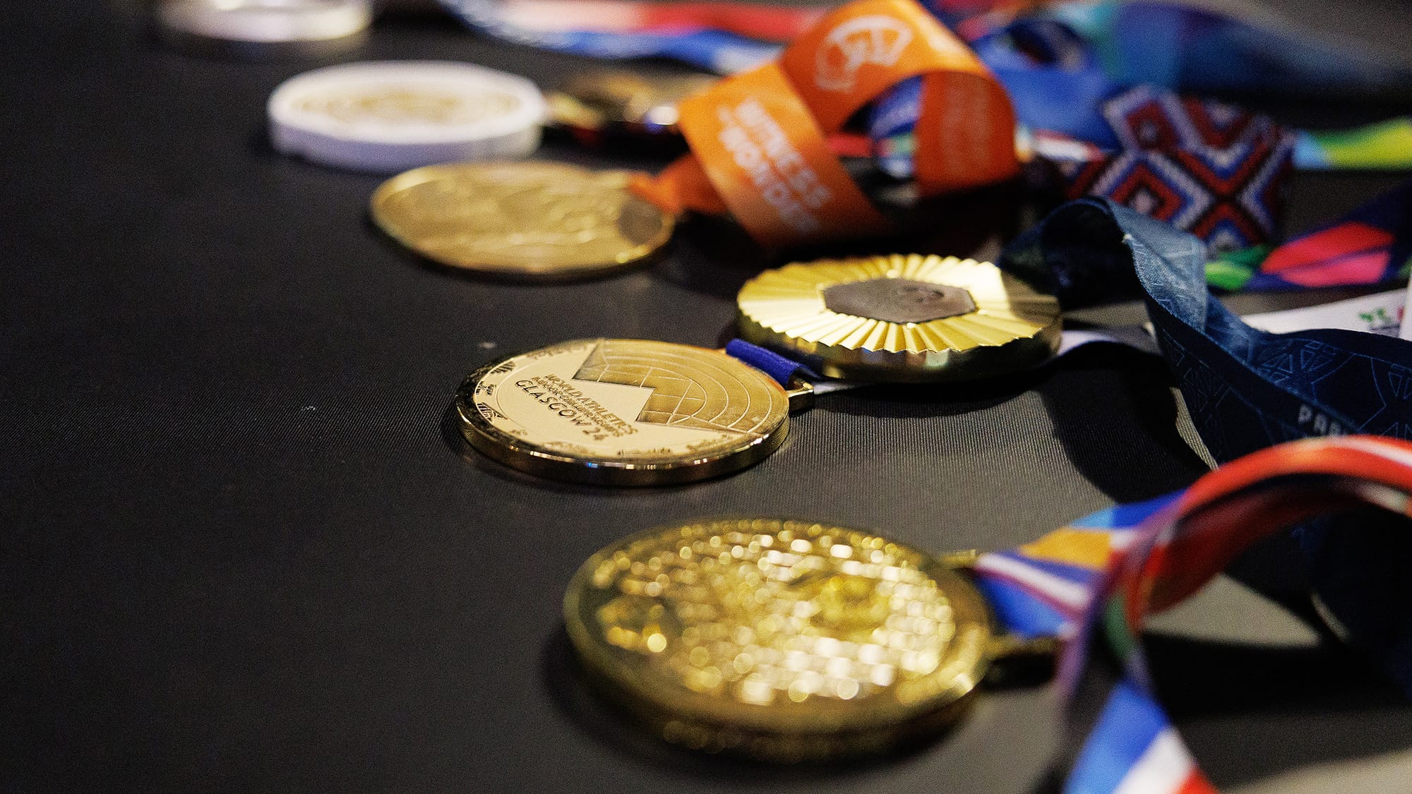 Grant Holloway's Olympic and World Championship hurdles medals lay on a table during a photoshoot in Weimer Hall at the University of Florida on Feb. 17, 2026.