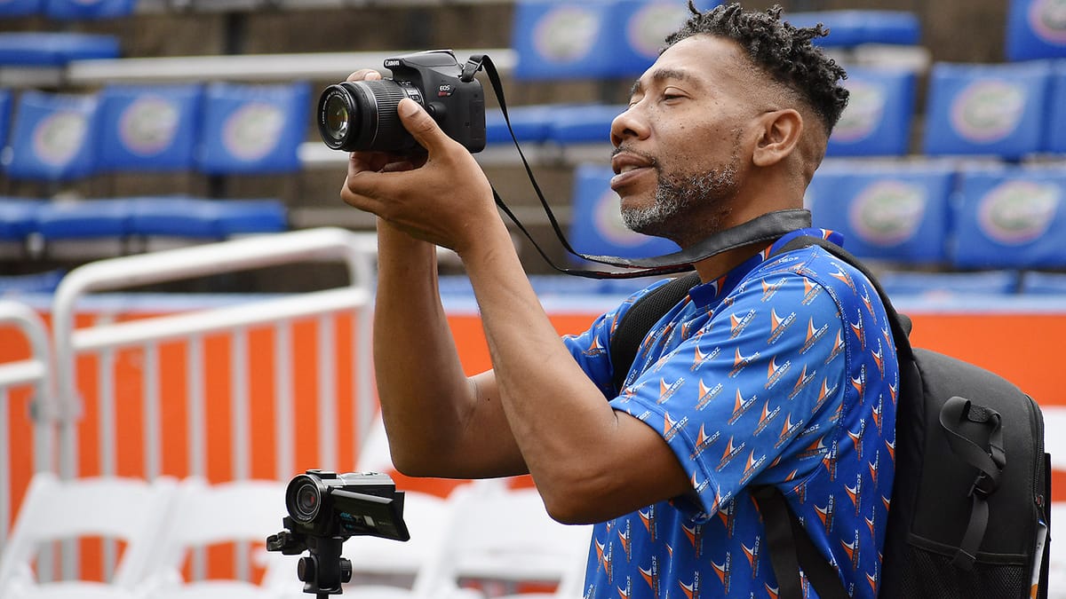 Corey Williams uses his camera to shoot at Ben Hill Griffin Stadium in November 2025.